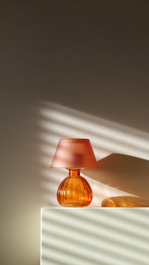 Lamp on fireplace with wall shadows from window screenshot