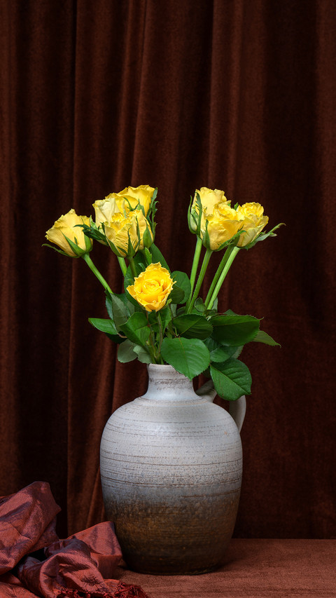 A beautiful bouquet of yellow roses in a gray vase screenshot
