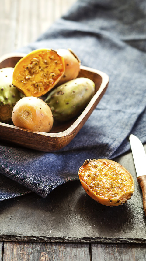 Wooden bowl of prickly pears on cloth and slate screenshot