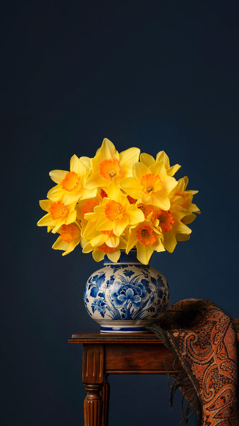Still life of daffodil bouquet in delft blue vase screenshot