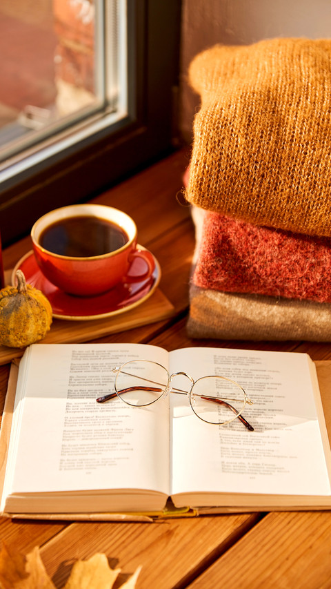 Open book with glasses, cup of coffee, autumn wool sweaters screenshot