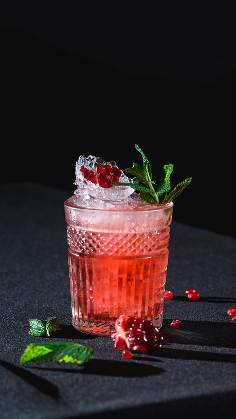 Cold cocktail with ice and garnet seeds screenshot