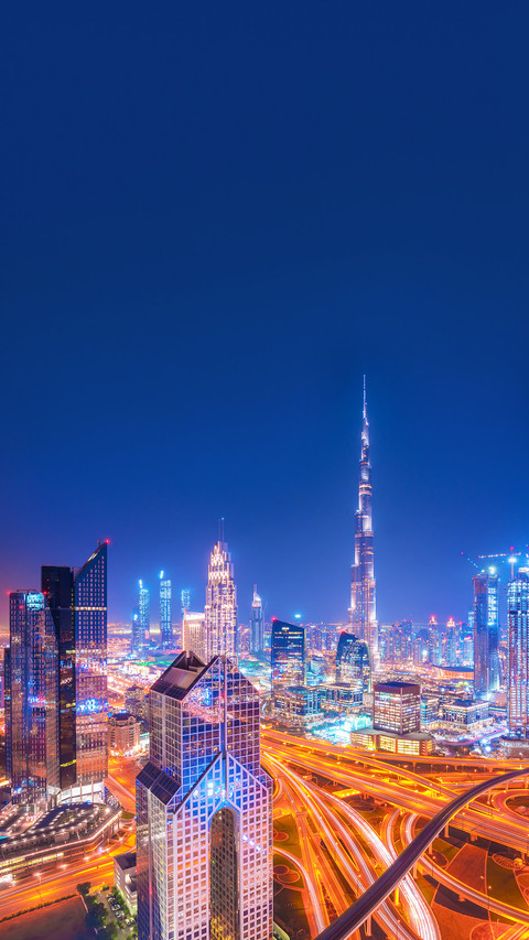 Modern Dubai skyline after the sunset with city center light screenshot