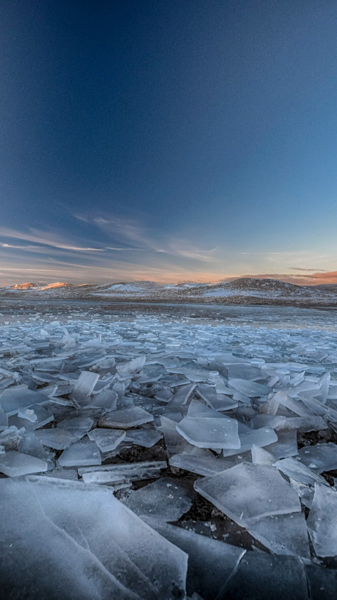 Ice cracks mirror mountain views screenshot