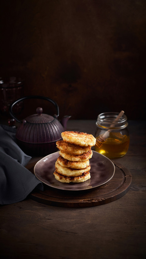 Russian fried quark pancakes with raw golden honey and tea screenshot