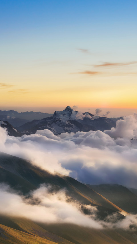 High Mountain Ridge in the Clouds during Sunrise screenshot