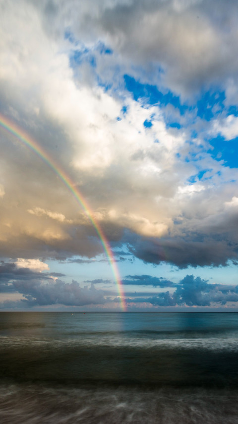 Rainbow spans the sky, beauty reflected screenshot