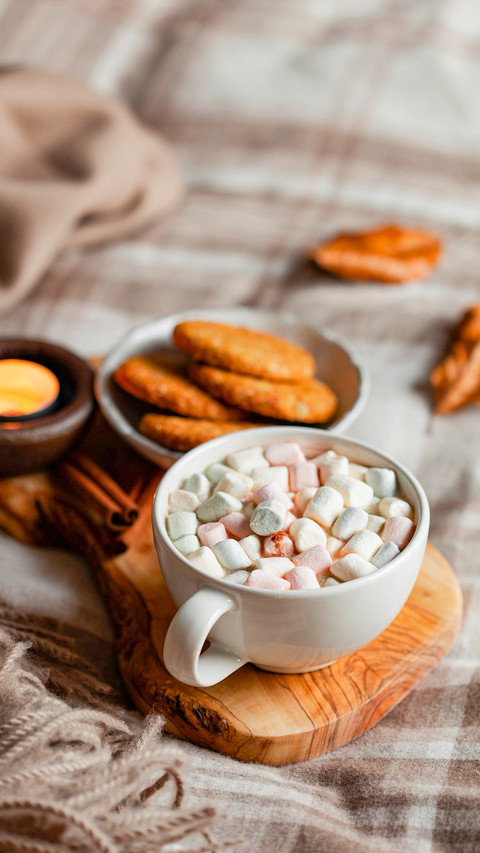 Warm cozy bedroom interior with cup of hot chocolate on tray screenshot