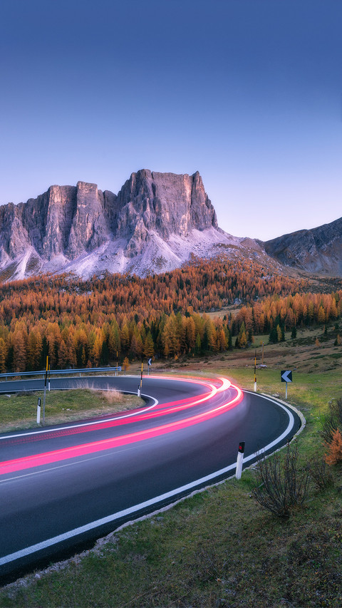 Winding Asphalt Road in Mountains at Sunset in Autumn screenshot