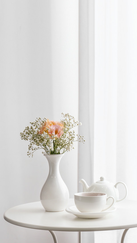 Vase with beautiful flowers and tea on table in room screenshot