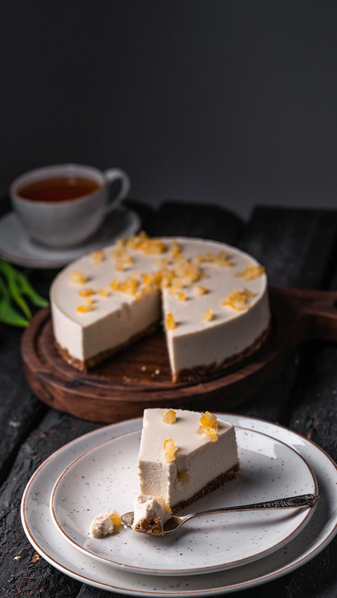 An image of cheesecake on a plate on a dark wooden backdrop screenshot