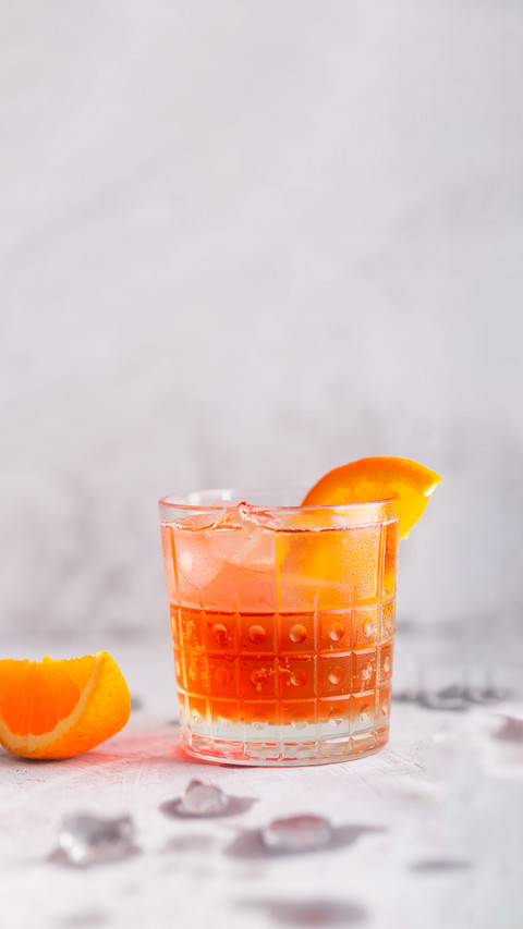 Fresh ice tea summer cocktail with orange and ice in glass screenshot