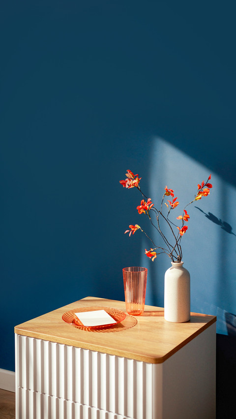 Minimalist still life with orange flowers in a vase screenshot