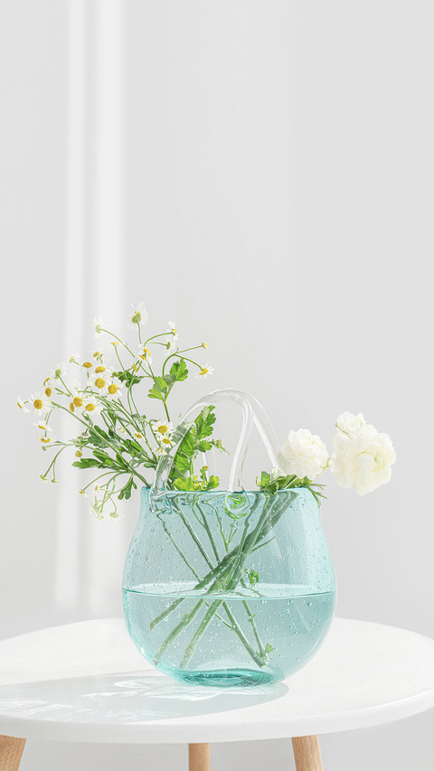 A Bunch of White Flowers Inserted in the Blue Glass Bottle screenshot