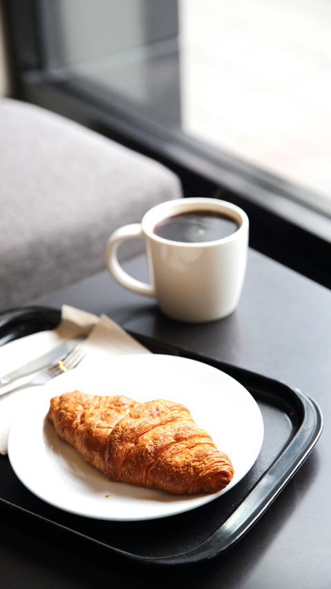 Croissant and coffee in coffee shop screenshot