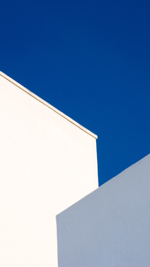 Two buildings reflecting the blue sky screenshot