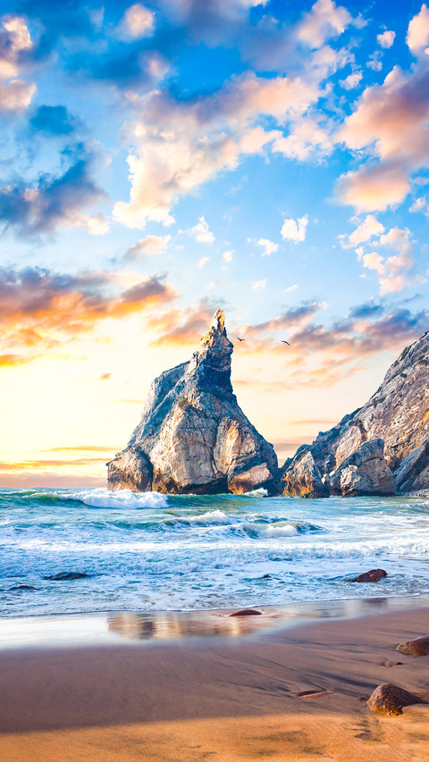 Fantastic big rocks and stones on the ocean beach at sundown screenshot