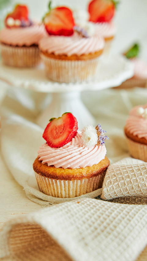 A vertical shot of delicious strawberry cupcakes screenshot