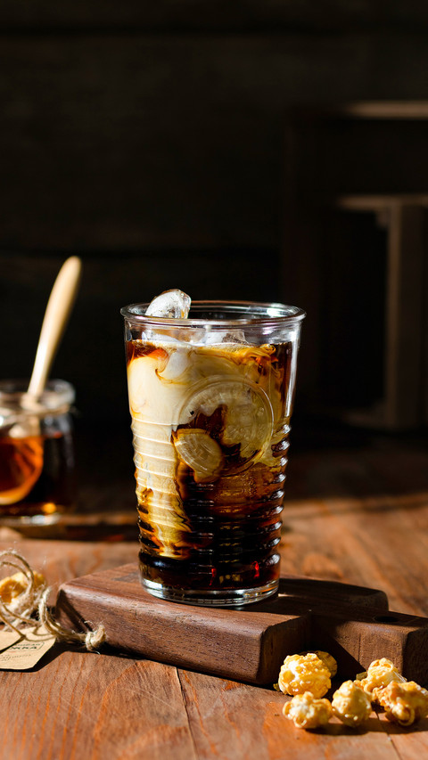 Iced coffee with cream on the table on a wooden board screenshot
