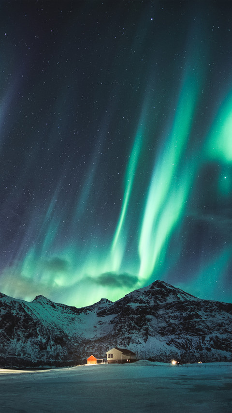 Northern Lights with Stars Glowing on Snowy Mountain screenshot