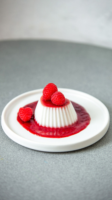 Vegan coconut raspberry panna cotta with berry decoration screenshot