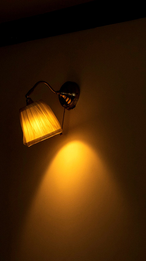 Lamp lit in living room illuminating wall screenshot