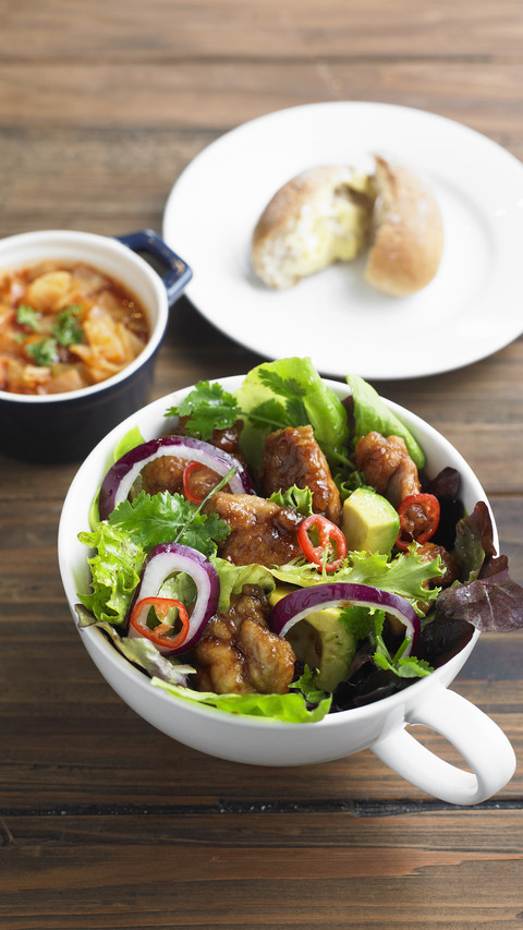 Chicken pieces in salad with red onion and avocado screenshot