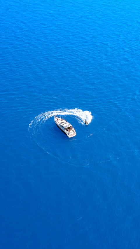 Water scooter movement close to the yacht aerial view screenshot