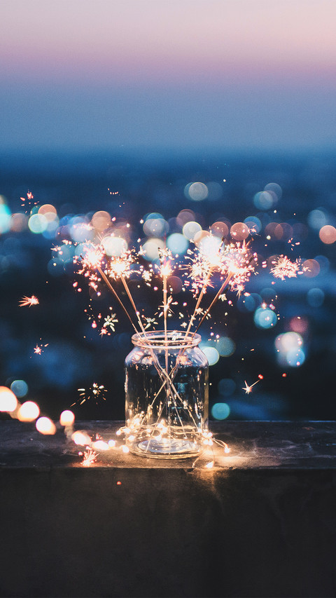 Sparklers in A Glass Jar That Bokeh Cities Background screenshot