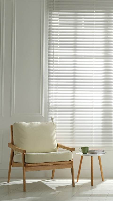 Cosy armchair and houseplant near large window screenshot