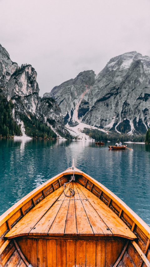 Wood boat in sea hills screenshot