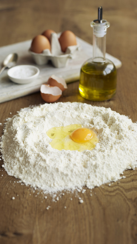 Egg olive oil and flour ready to be mixed together making screenshot