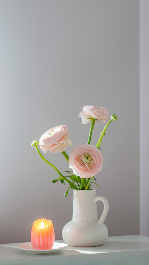 Spring flowers in vase in white modern interior screenshot