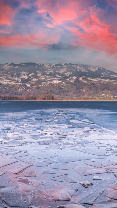 Breathtaking sunset over frozen lake like a painting. screenshot