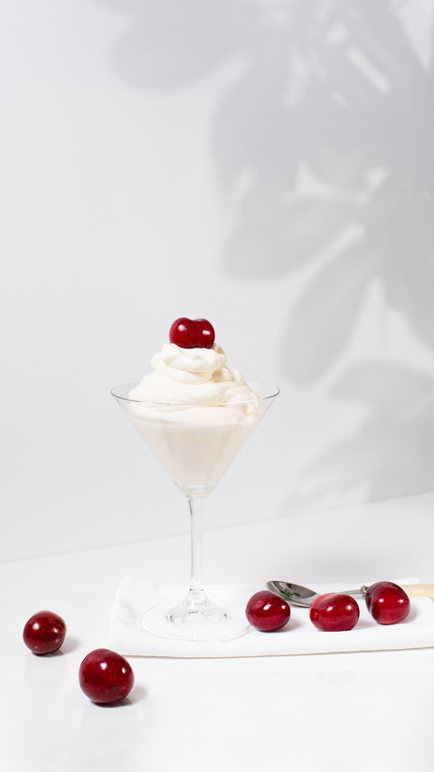 Ice Cream with Sweet Cherries in Cocktail Glass on table screenshot