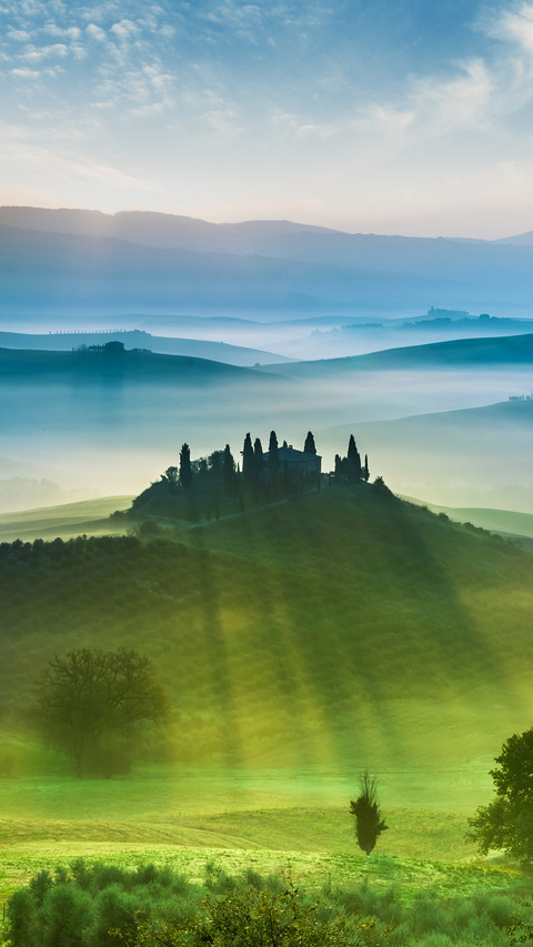 view of green fields and meadows at sunset in Tuscany screenshot