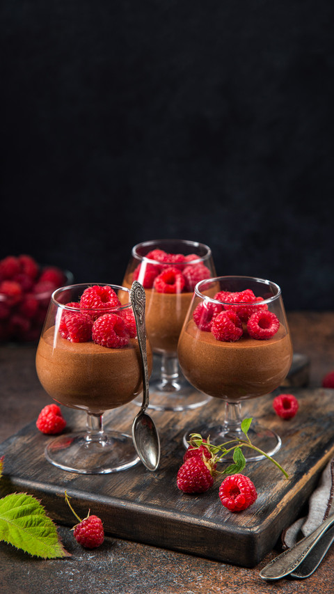 Delicious chocolate mousse served with fresh raspberr screenshot