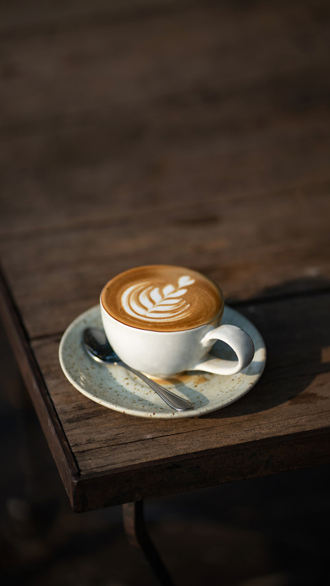 Coffee on the corner of a wooden table screenshot