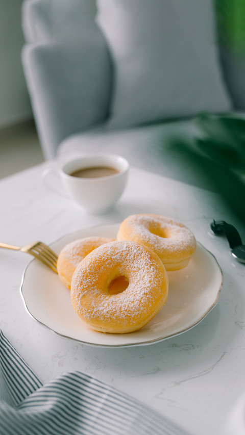 Classic donut and coffee on white table screenshot
