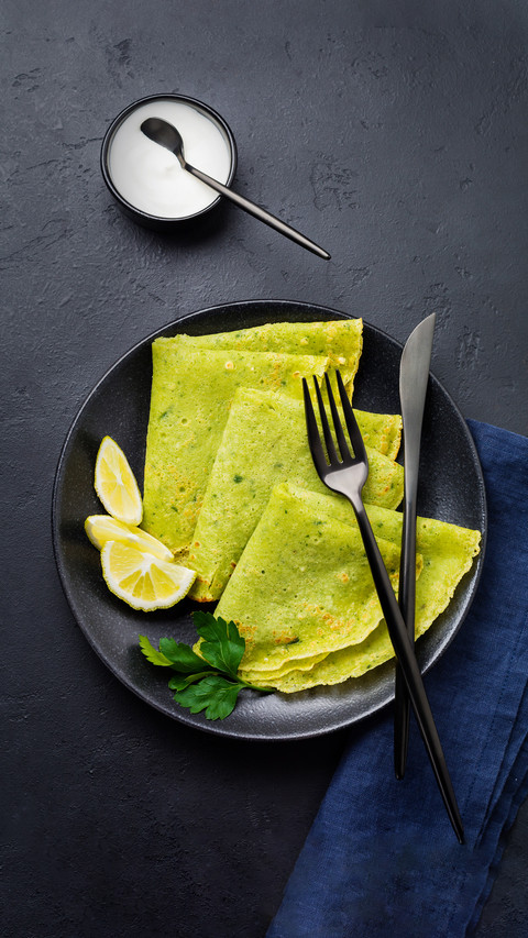 Crepes of Spinach with Yoghurt Sauce on Black Concrete screenshot
