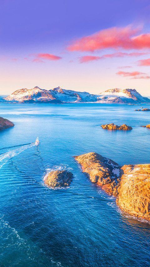 Aerial view of fishing boats, rocks in the blue sea screenshot