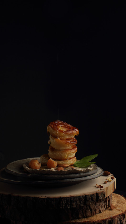 Pancakes with nuts and honey on a black background screenshot