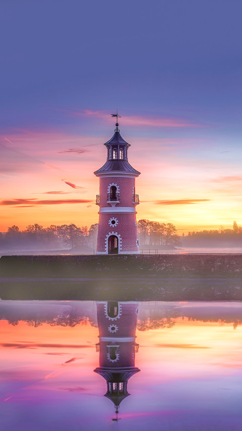 The reflection of Leuchtturm historical landmark at sunset screenshot