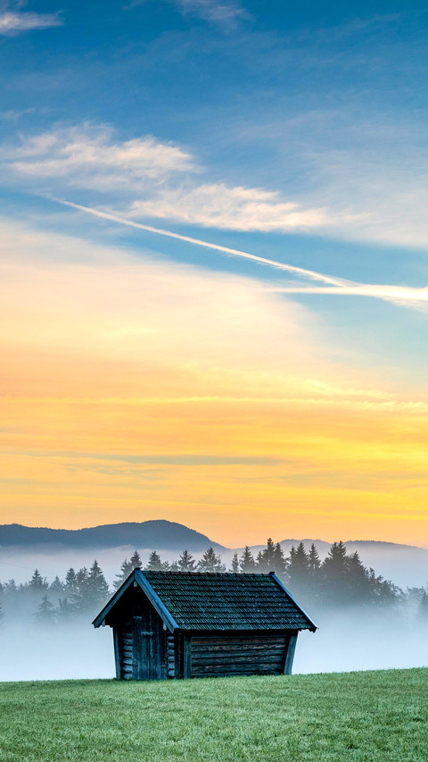 Mountain meadow with small hut with light ground fog screenshot
