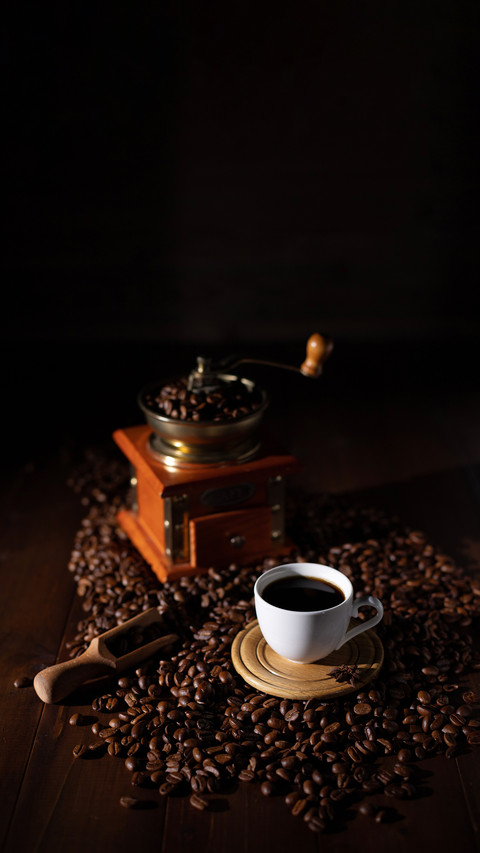 Cup of coffee and beans on wooden table screenshot