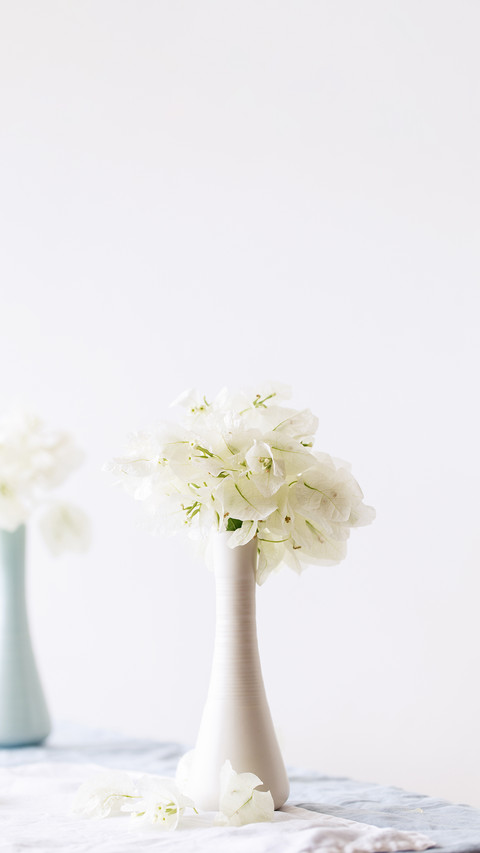 Vase with bougainvillaea flowers on the table screenshot