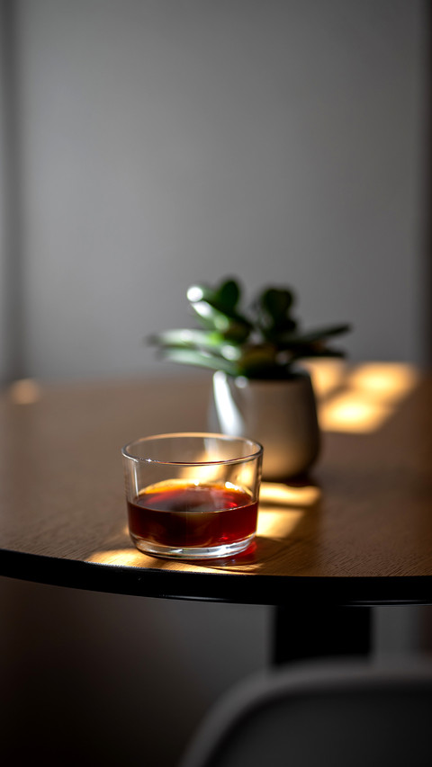 Black filter coffee on the table in cafe glass cup screenshot