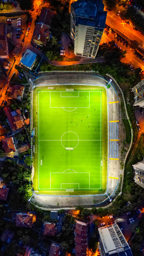 Drone-Captured Aerial View of Soccer Field Amidst Play screenshot