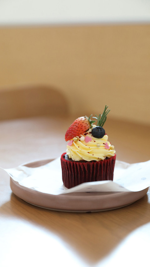 Colorful cupcakes on wood table background screenshot