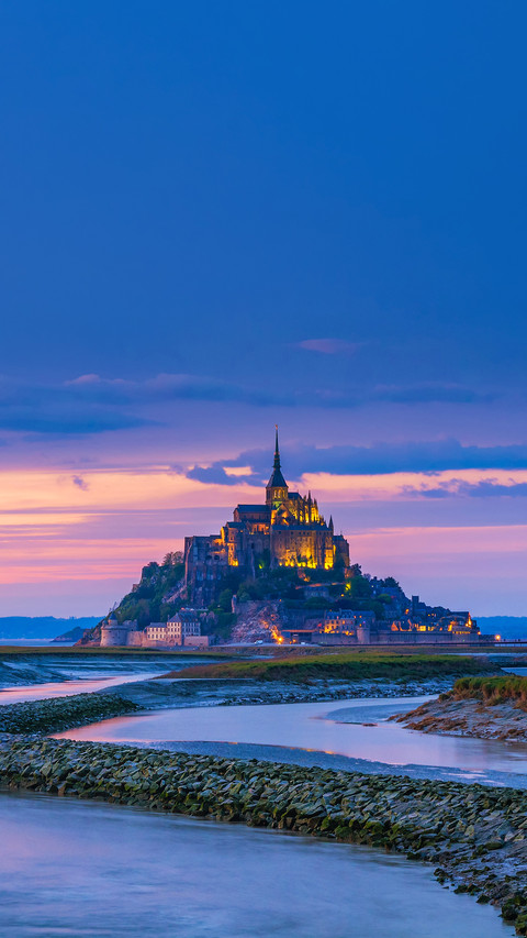 View of famous Le Mont Saint-Michel tidal island at sunset screenshot